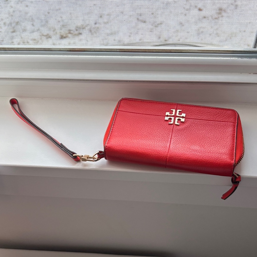 Tory  Burch orange leather wristlet wallet.